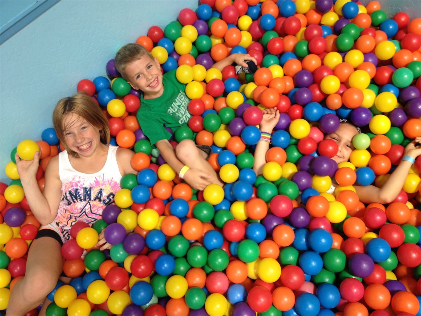Kids smiling in the ball pit at Black Diamond