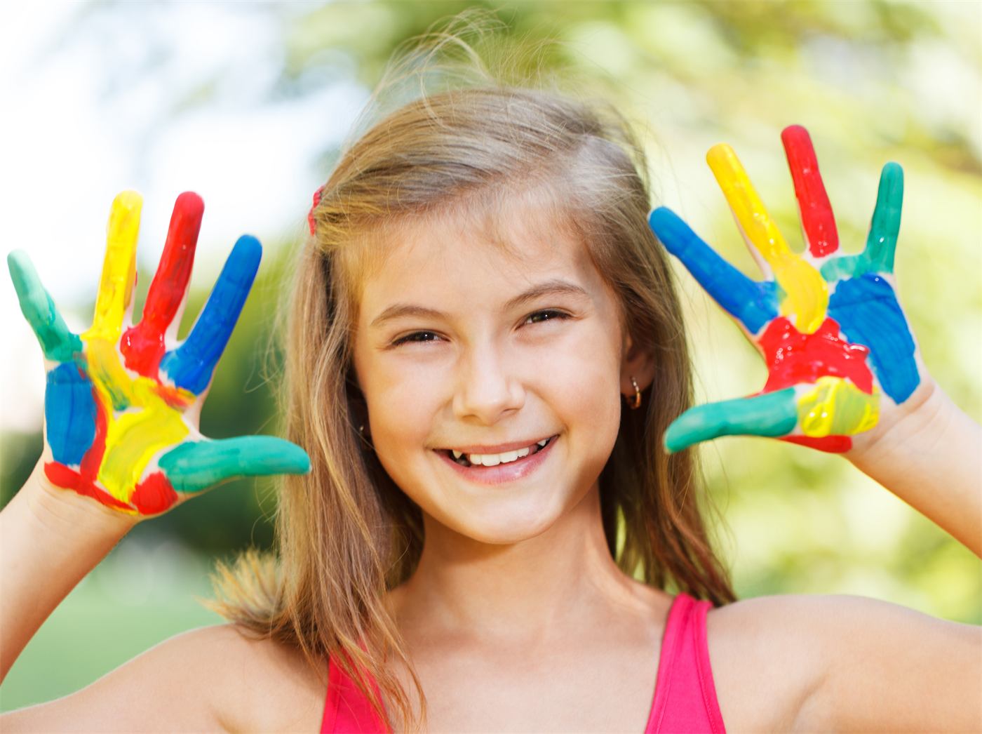 Smiling girl with painted hands