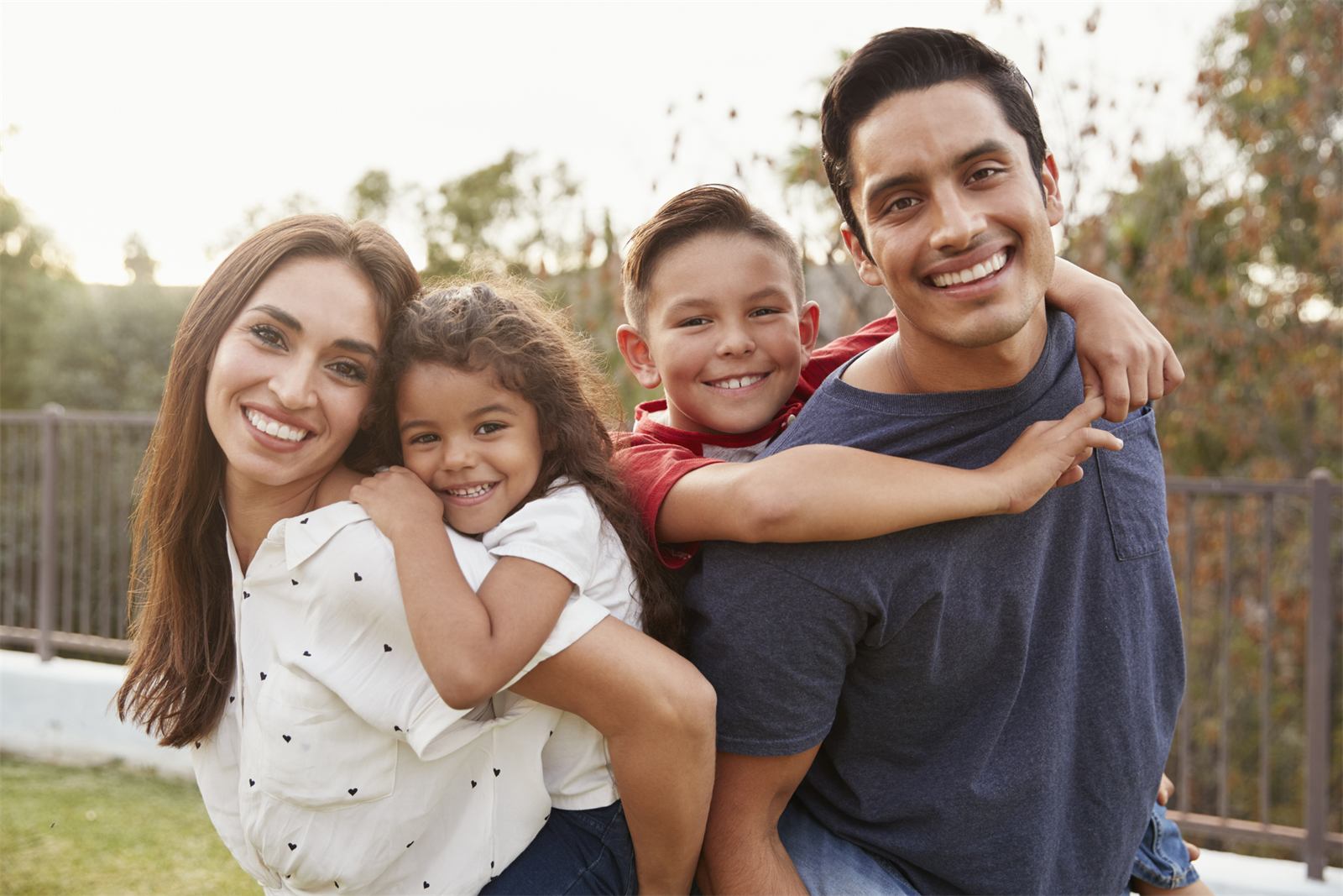 Smiling family of four outdoors