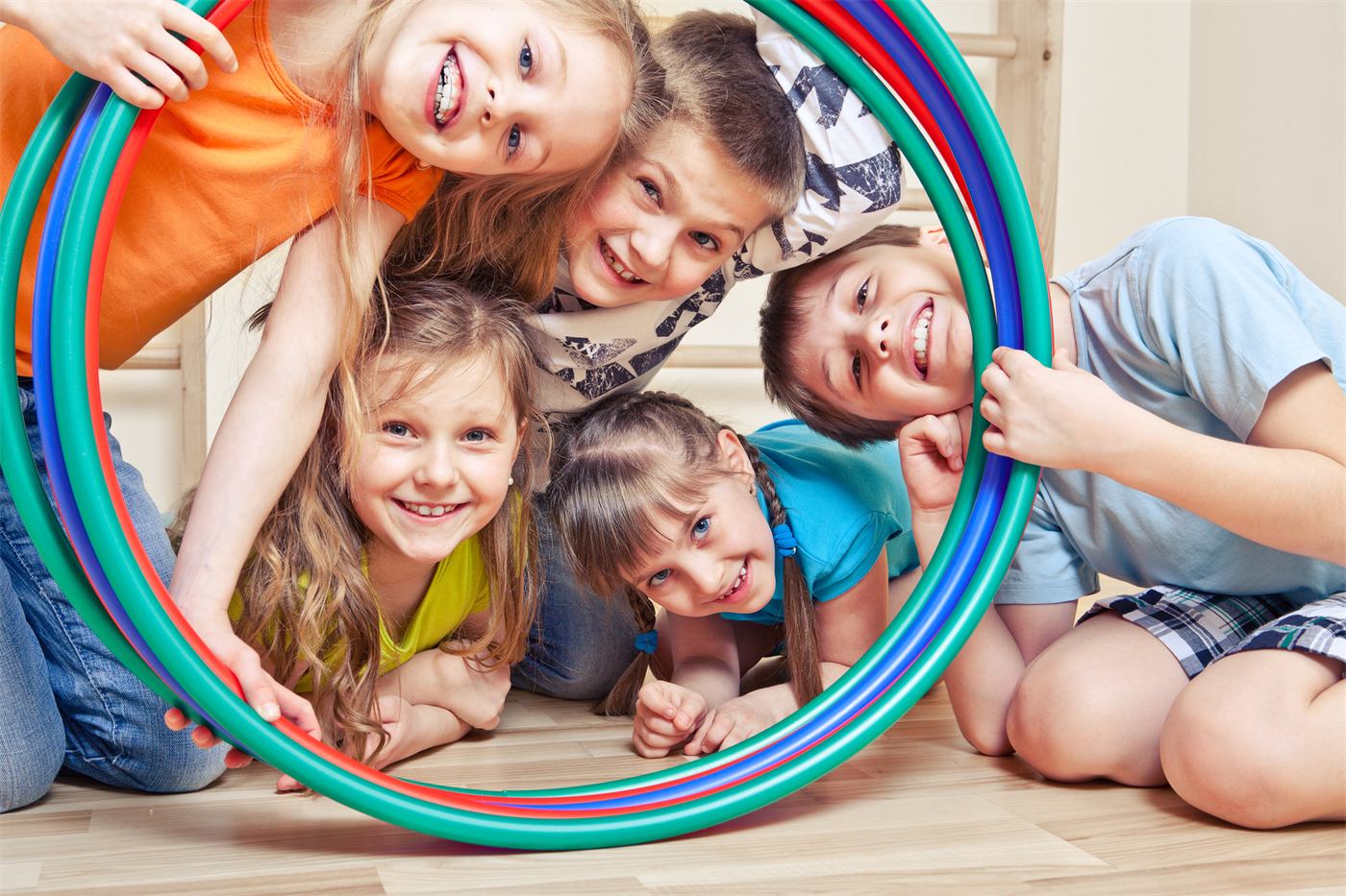 Kids laughing through a hula hoop