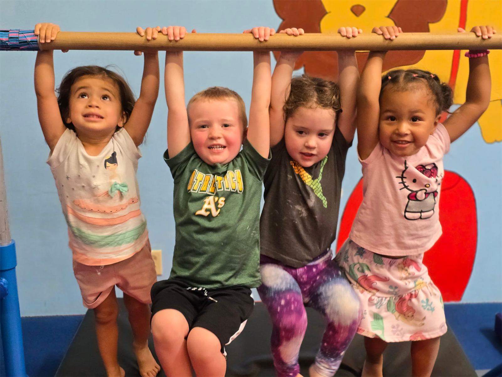 Little Diamonds preschoolers hanging from a bar