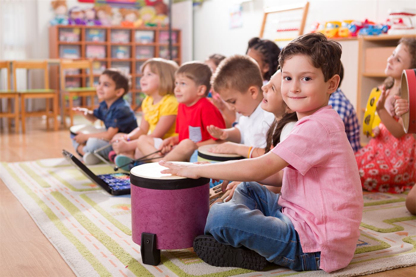 Preschoolers playing drums during music time